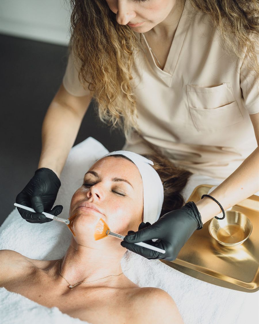 Yulia applying the personalised glow peel with a fan brush during a ProGlow